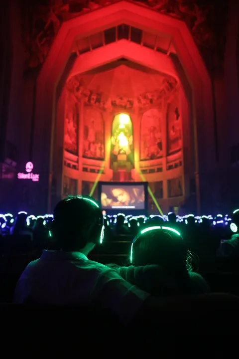 Público de Silent Cinema con audífonos luminosos durante la proyección